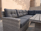Close-up of the Atrico Lounge Set wicker corner sofa with tufted grey cushions and slatted coffee table