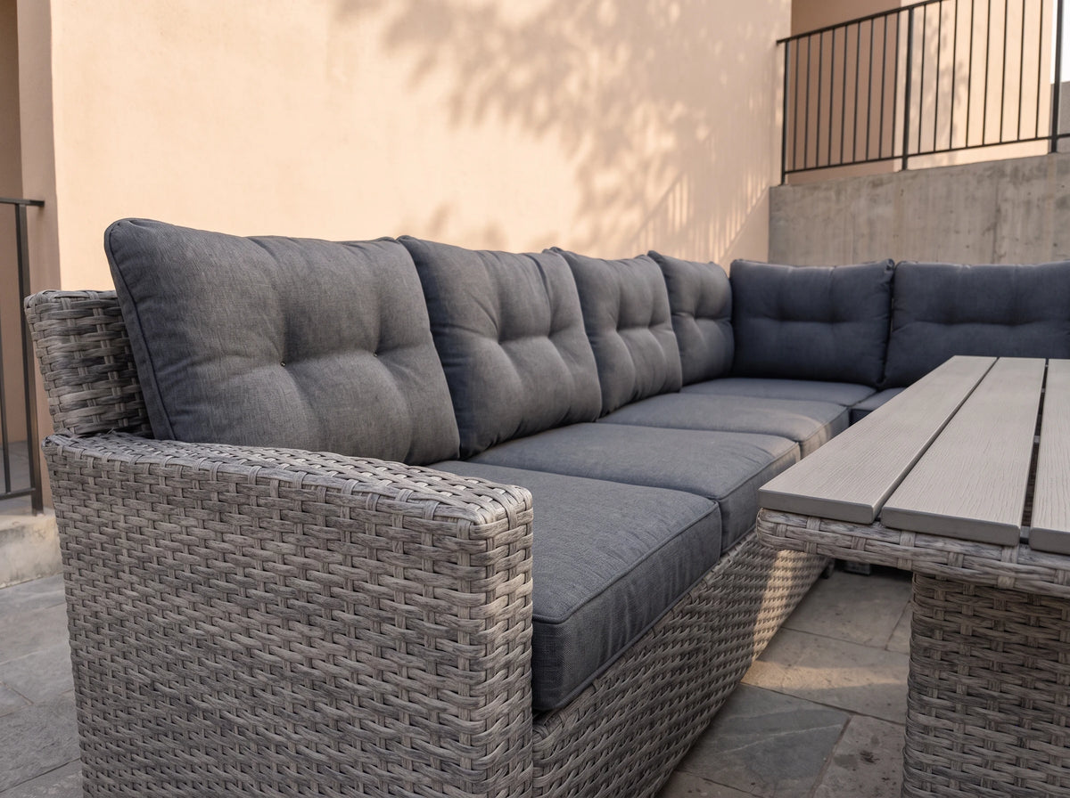Close-up of the Atrico Lounge Set wicker corner sofa with tufted grey cushions and slatted coffee table