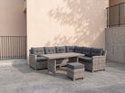 Atrico Lounge Set corner sofa, coffee table and stool on a modern villa terrace with a beige wall